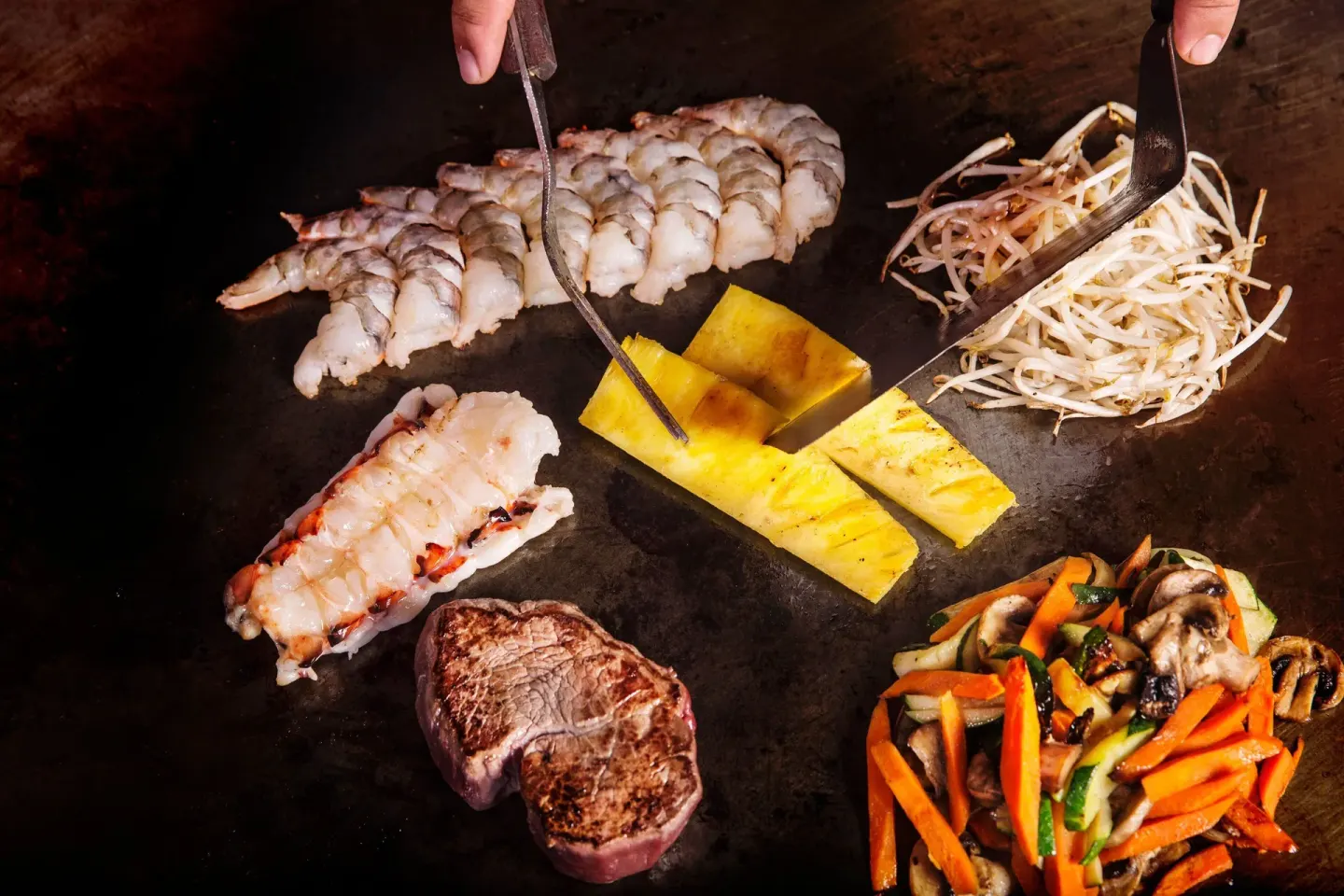 Teppanyaki grill with seafood, steak, pineapple, and vegetables at Sheraton Maui Resort & Spa.