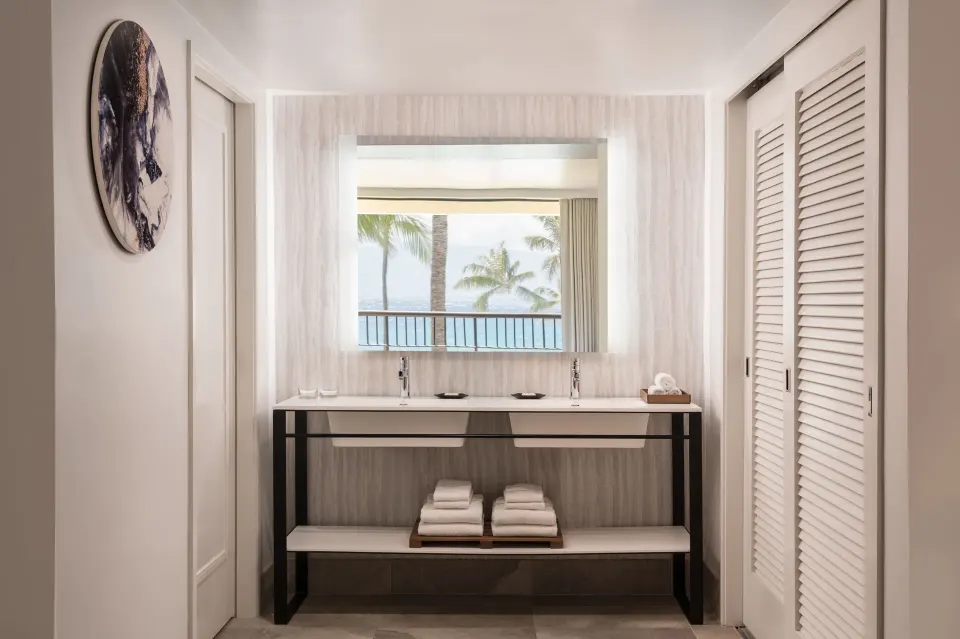 Suite bathroom vanity with ocean reflected in the mirror at Sheraton Maui Resort & Spa.