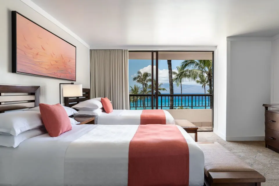 Two double beds in an ocean view suite bedroom at Sheraton Maui Resort & Spa.
