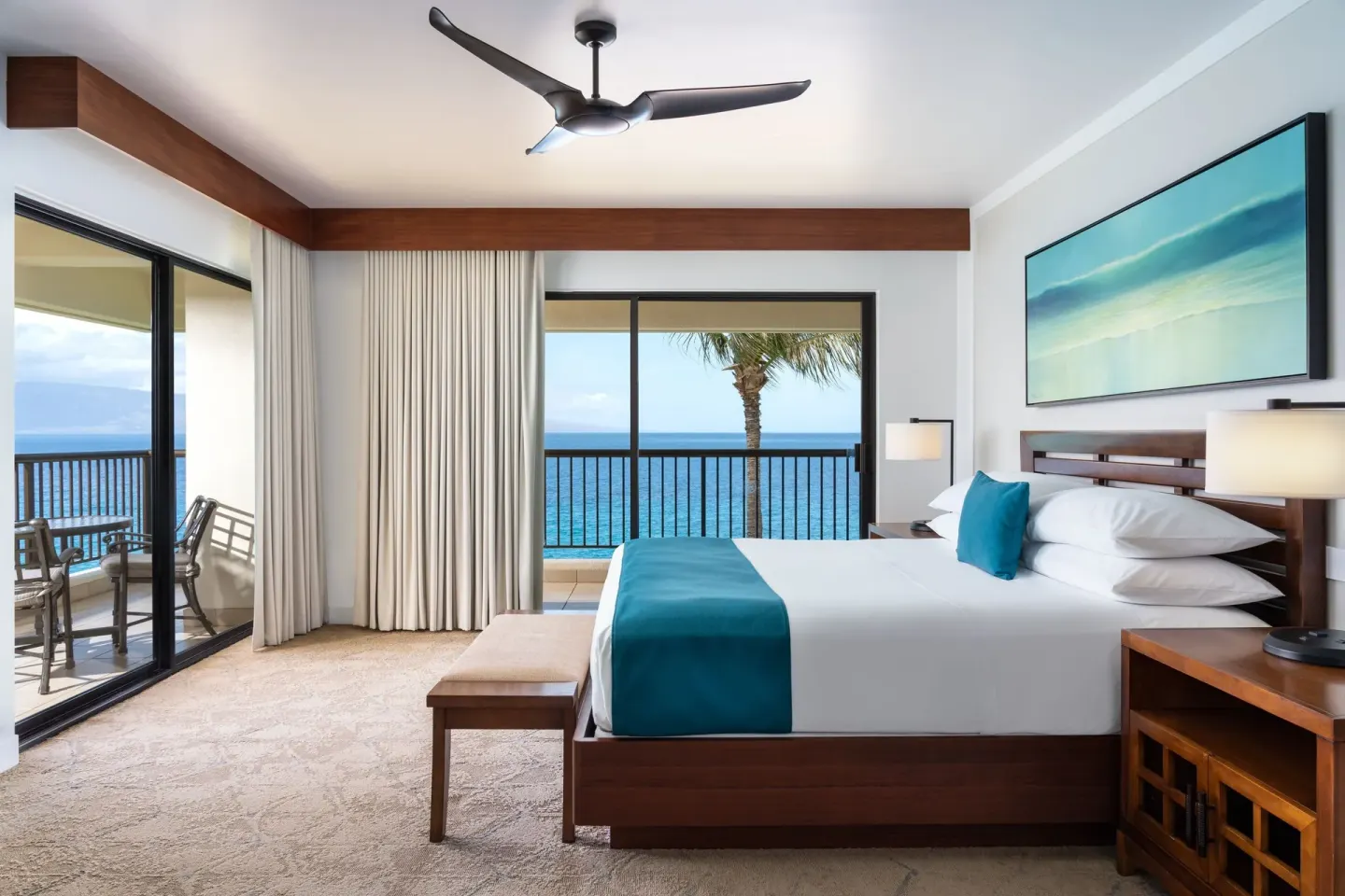 King bed in the Moana Oceanfront 1 Bedroom Suite at Sheraton Maui Resort & Spa facing the ocean.