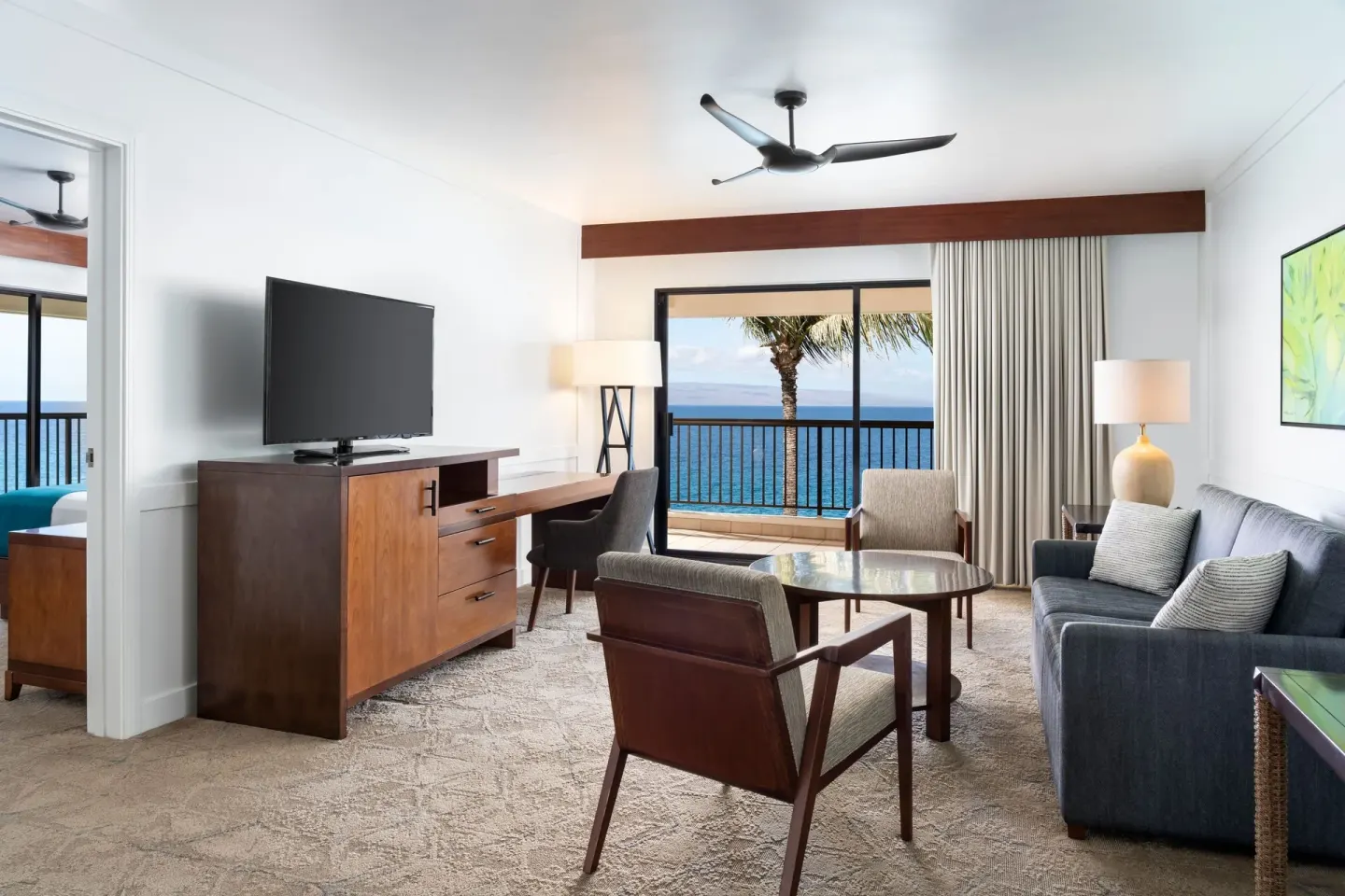 Living room of the Moana Oceanfront 1 Bedroom Suite at Sheraton Maui Resort & Spa with ocean view.