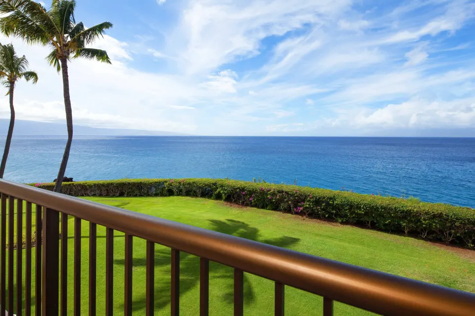 Moana Oceanfront balcony with lawn, palms, and blue ocean at Sheraton Maui Resort & Spa.
