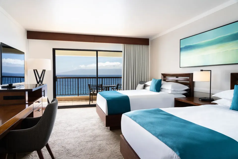 Moana Oceanfront room with two beds and ocean-facing balcony at Sheraton Maui Resort & Spa.