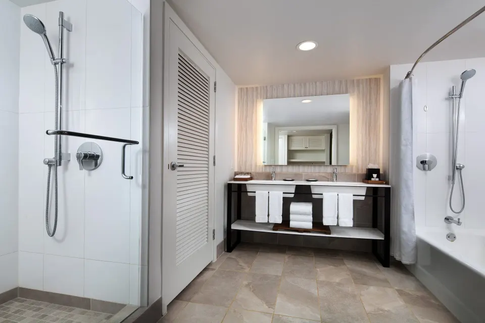 Ohana Suite bathroom with double vanity, shower, and tub at Sheraton Maui Resort & Spa.
