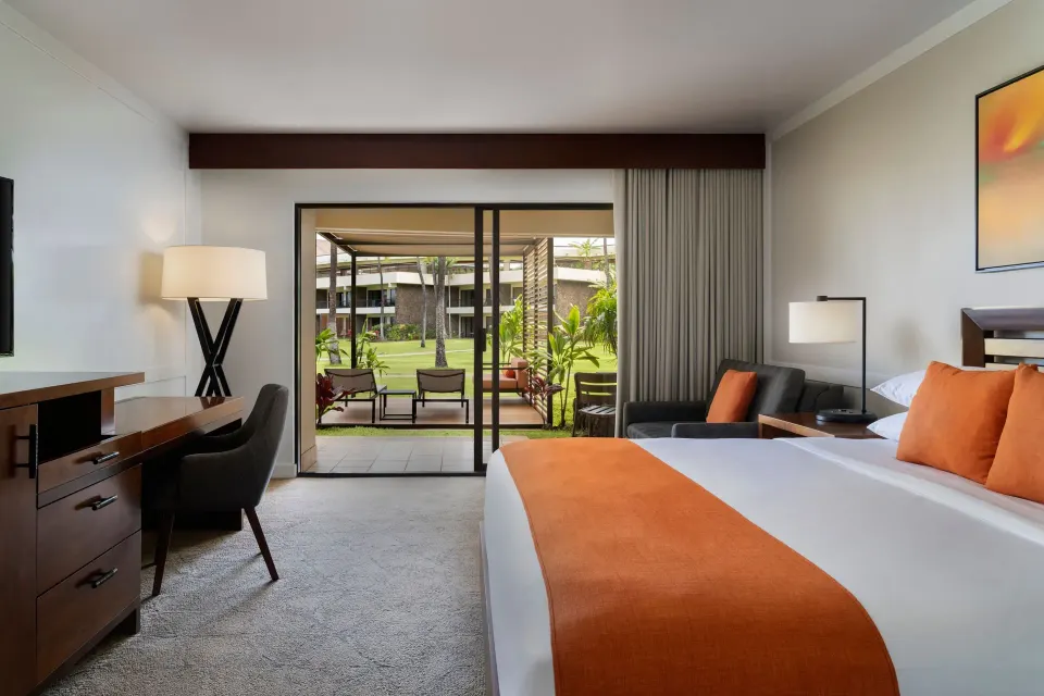 Premium Lanai king guest room opening to a furnished patio at Sheraton Maui Resort & Spa.