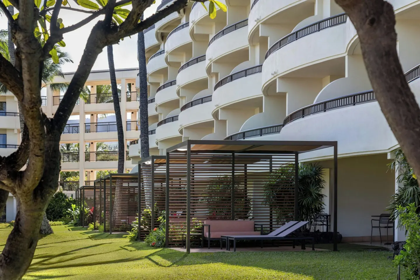 Premium Lanai patios with lounge seating beside the resort building at Sheraton Maui Resort & Spa.