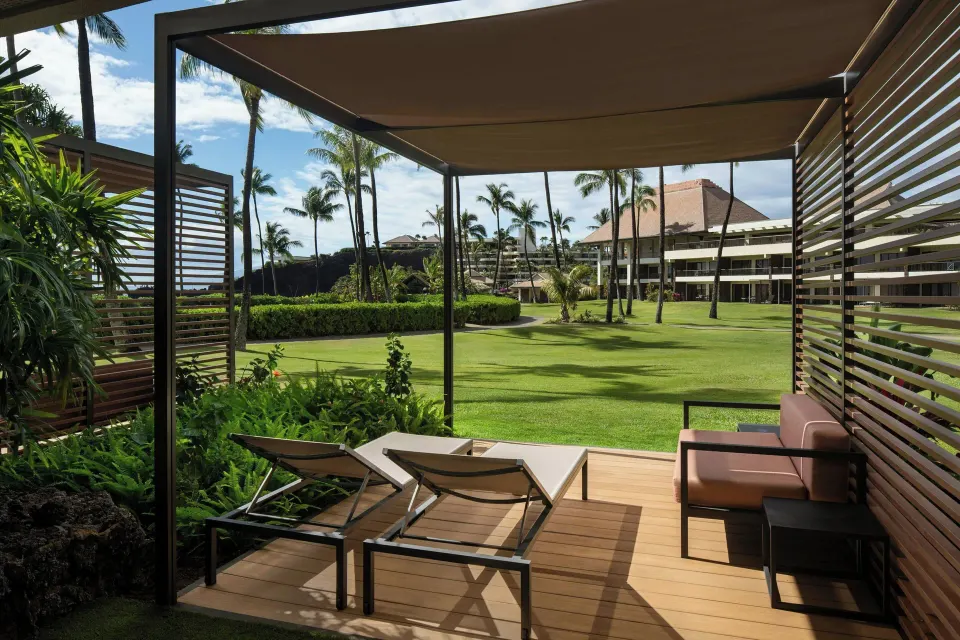 Shaded Premium Lanai patio overlooking lawns and palms at Sheraton Maui Resort & Spa.