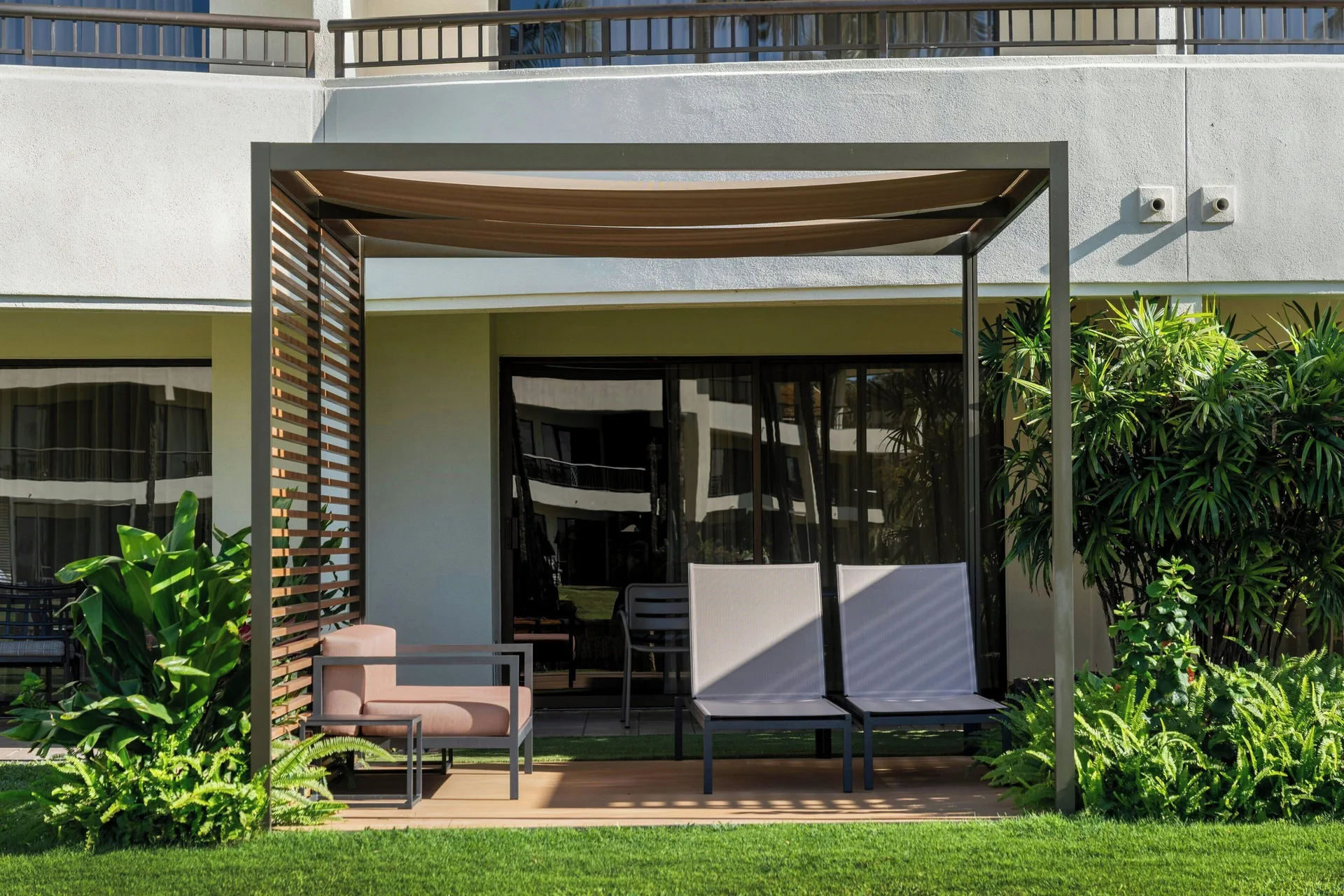 Premium Lanai room with private patio and two loungers at Sheraton Maui Resort & Spa offering spacious outdoor living on Maui.