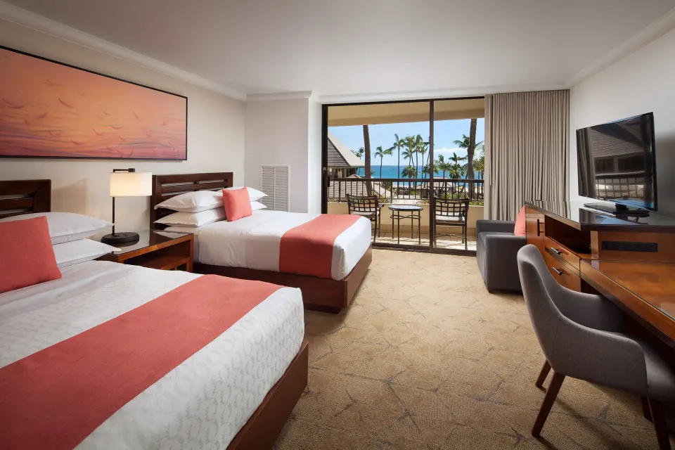 Two queen beds in an ocean view room with balcony at Sheraton Maui Resort & Spa.