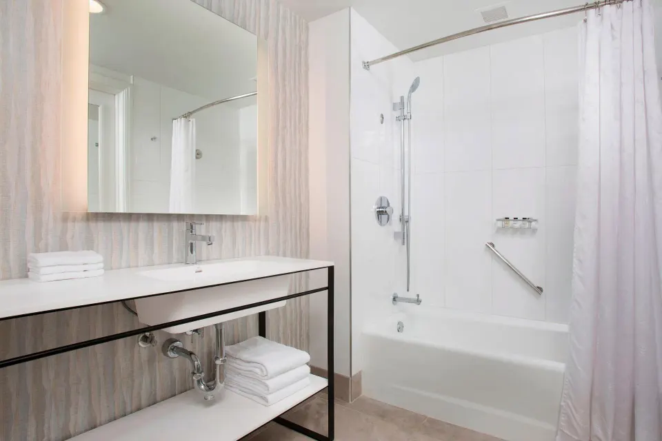 Resort View room bathroom with vanity and tub-shower at Sheraton Maui Resort & Spa.