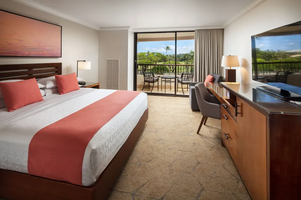 King bed Resort View room with balcony seating and TV at Sheraton Maui Resort & Spa.