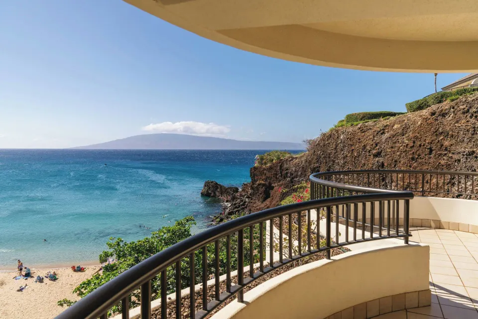 Curved suite balcony overlooking ocean and rocky coast at Sheraton Maui Resort & Spa.