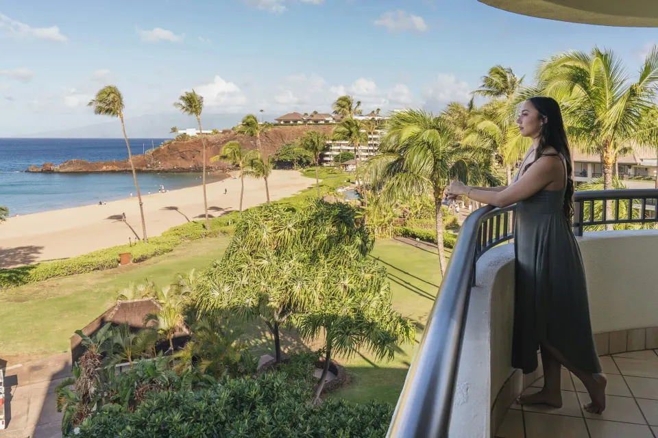 Guest on oceanfront suite balcony at Sheraton Maui Resort & Spa.