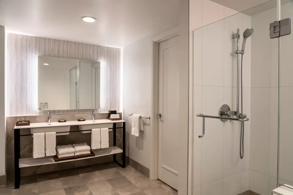 Suite bathroom with double vanity and glass shower at Sheraton Maui Resort & Spa.