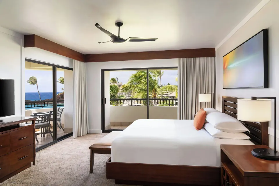 Oceanfront one-bedroom suite king bed and balcony at Sheraton Maui Resort & Spa.