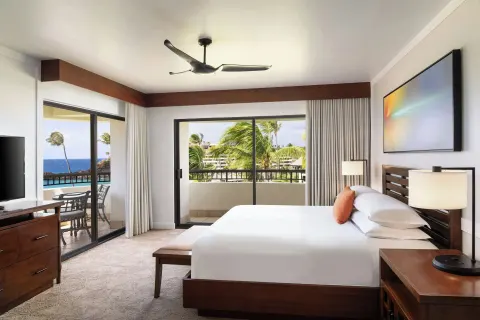 Oceanfront one-bedroom suite king bed and balconies at Sheraton Maui Resort & Spa.