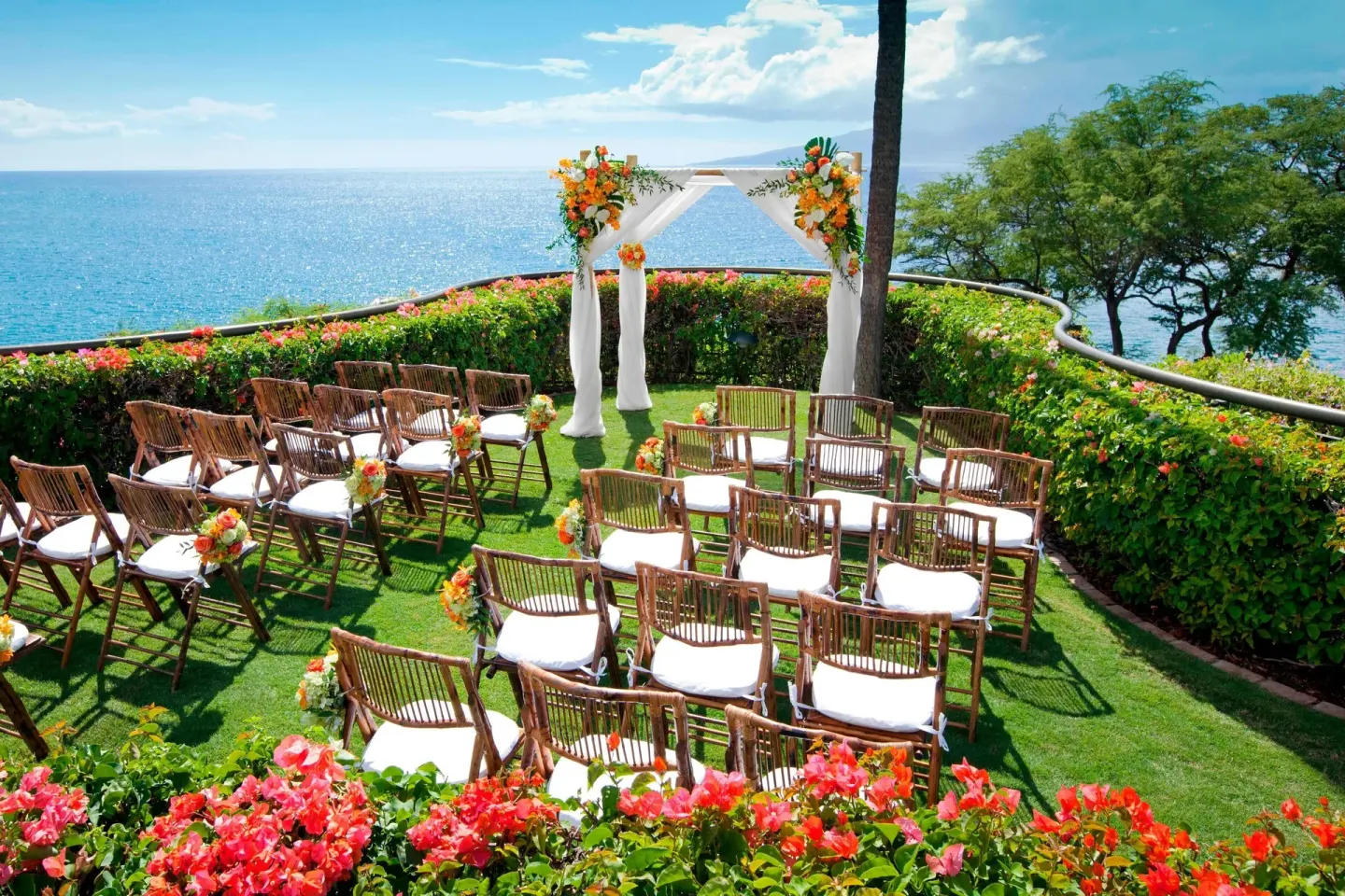 Oceanfront wedding ceremony lawn with floral arch at Sheraton Maui Resort & Spa.