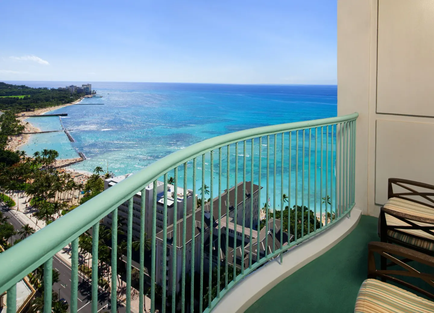 Balcony chairs and railing overlooking Waikiki Beach at Sheraton Princess Kaiulani.