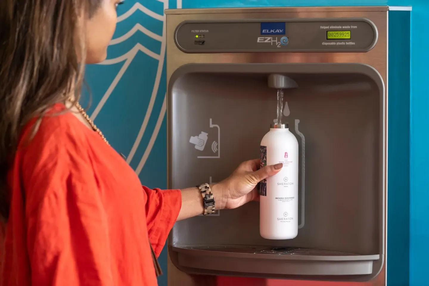 A guest fills a reusable water bottle at Sheraton Princess Kaiulani.