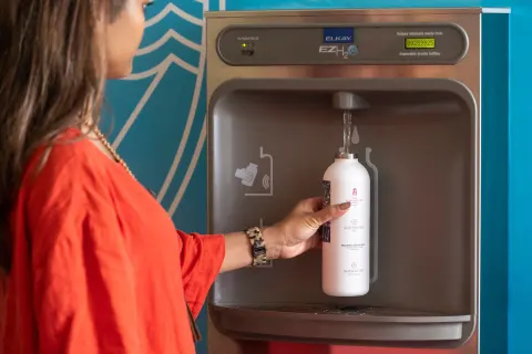 A guest fills a reusable water bottle at Sheraton Princess Kaiulani.