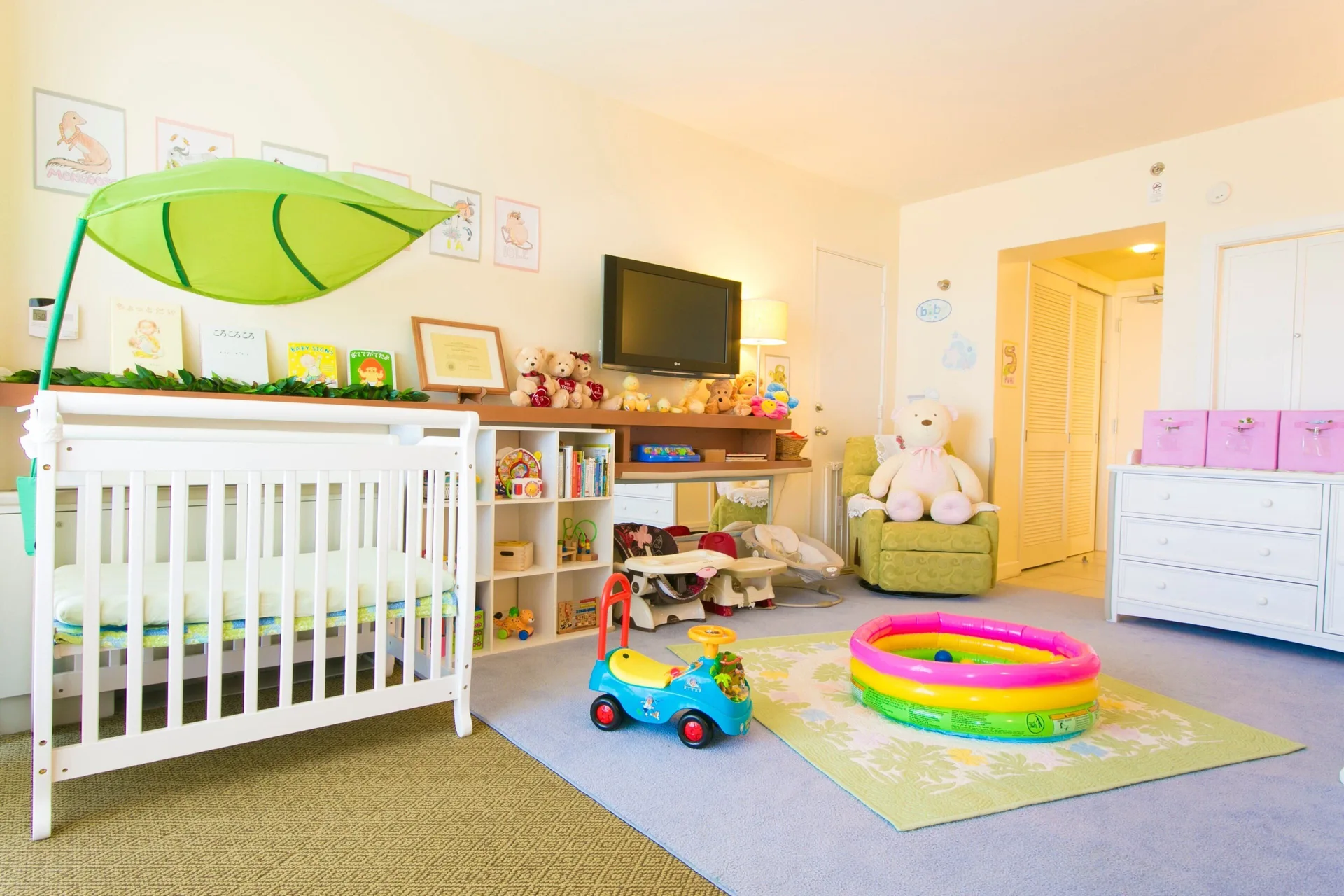Children's playroom with crib, toys, and colorful decor at Sheraton Waikiki Beach Resort.