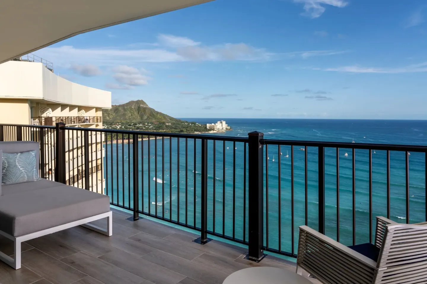 Spacious balcony with seating and Diamond Head ocean view at Sheraton Waikiki Beach Resort.