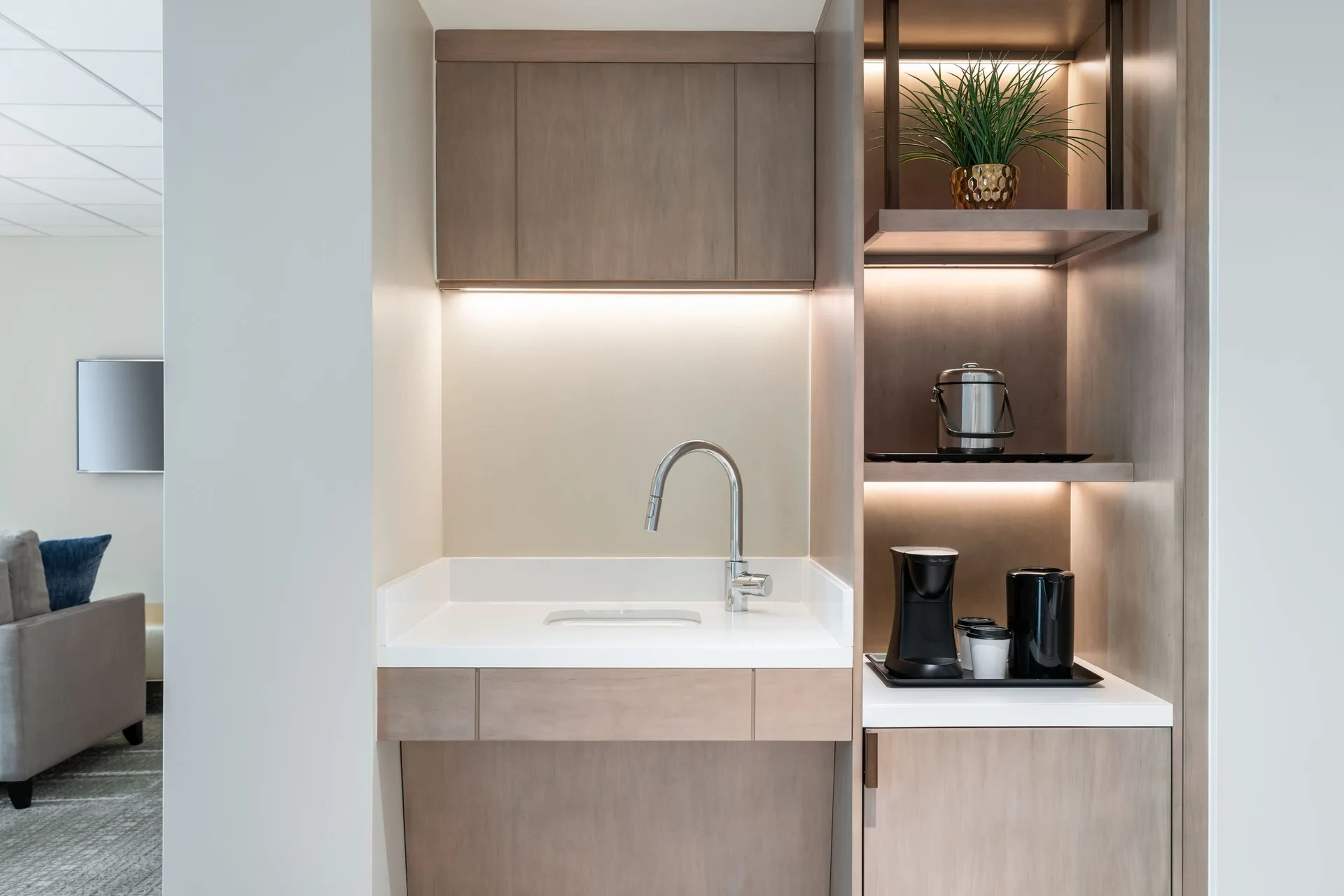 Guest room wet bar with sink, shelves, and coffee setup at Sheraton Waikiki Beach Resort.