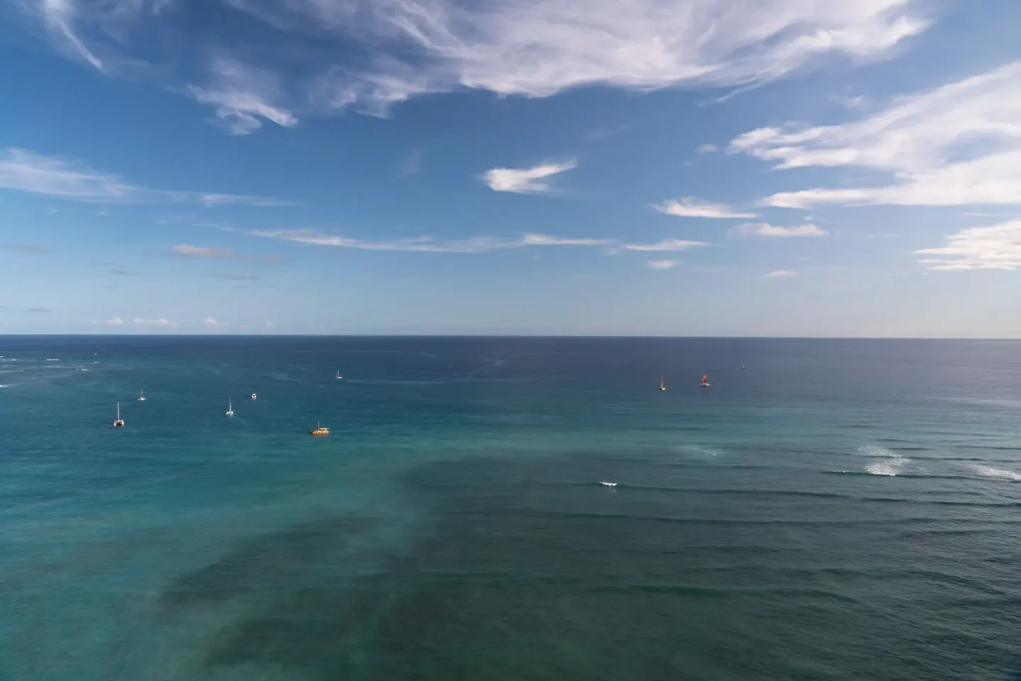 Wide Pacific Ocean view with sailboats near Sheraton Waikiki Beach Resort.