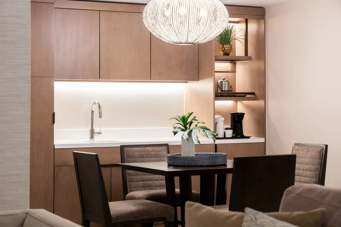 Suite dining area with kitchenette and pendant light at Sheraton Waikiki Beach Resort.