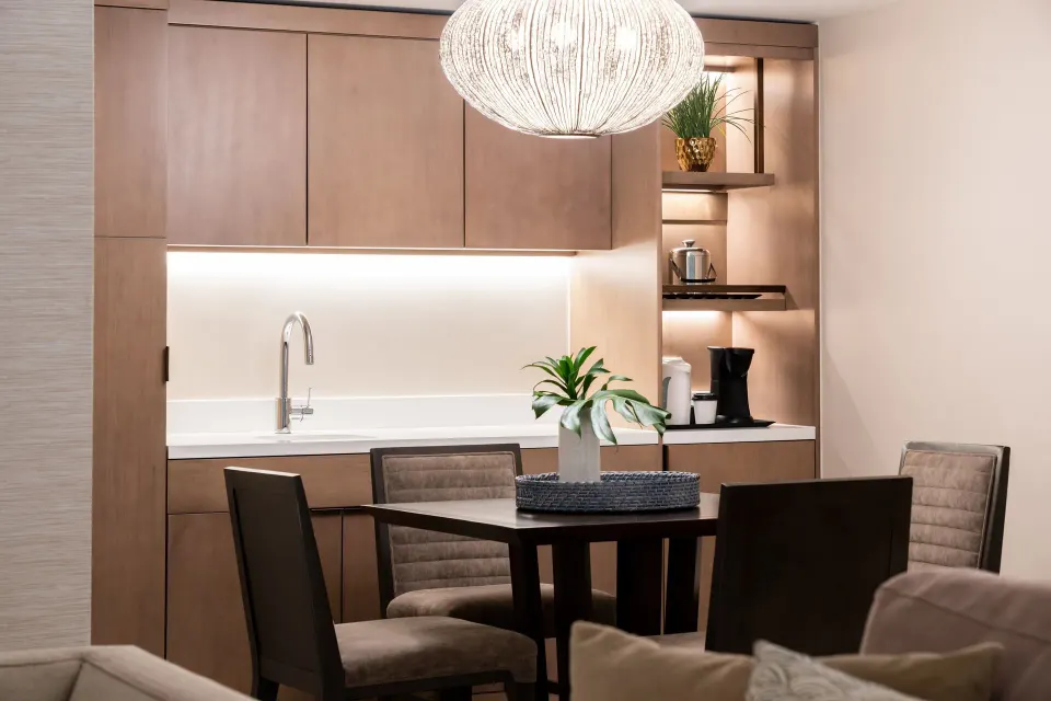 Suite dining area with kitchenette and pendant light at Sheraton Waikiki Beach Resort.