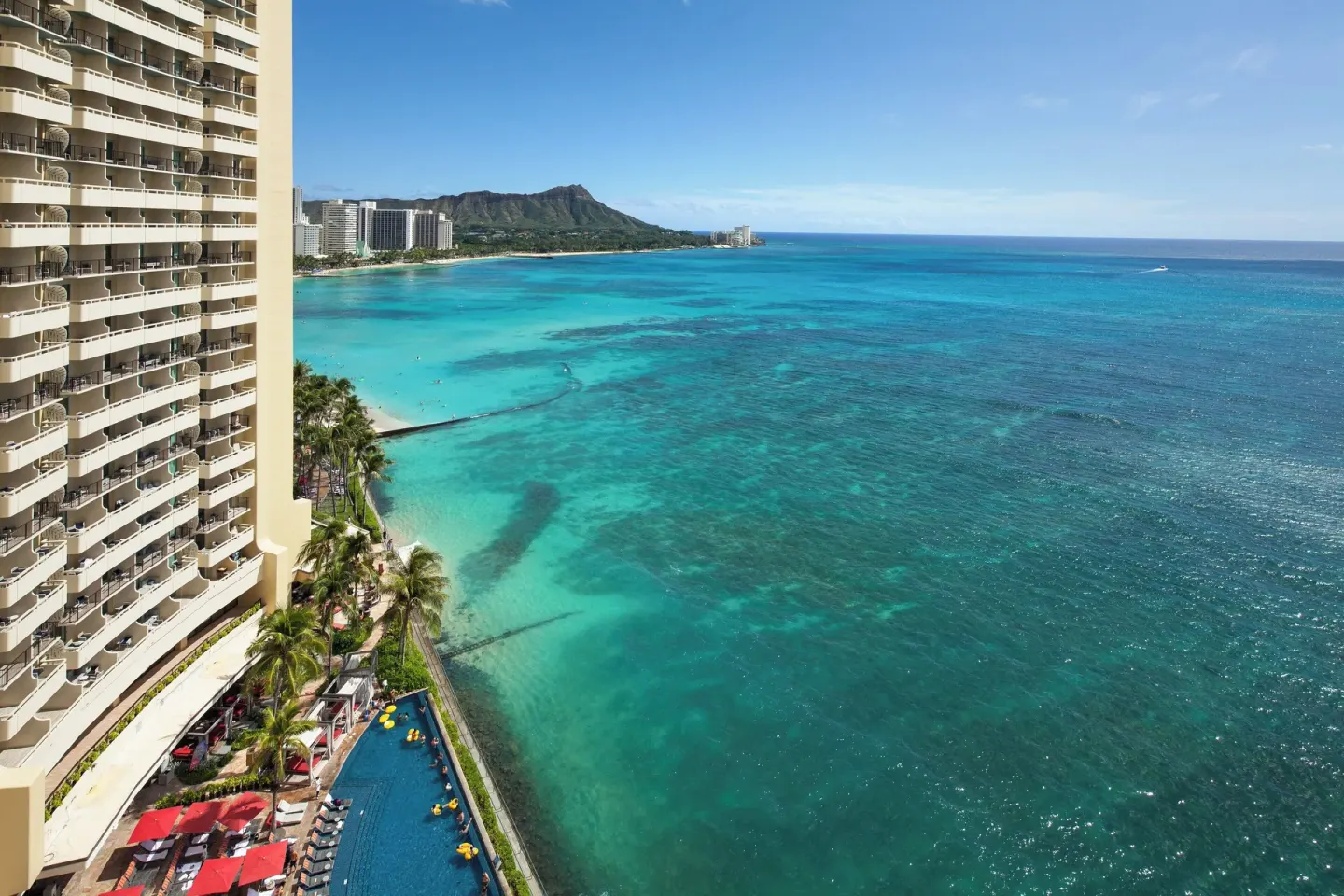 Waikiki coastline, resort tower, pool, and Diamond Head at Sheraton Waikiki Beach Resort.