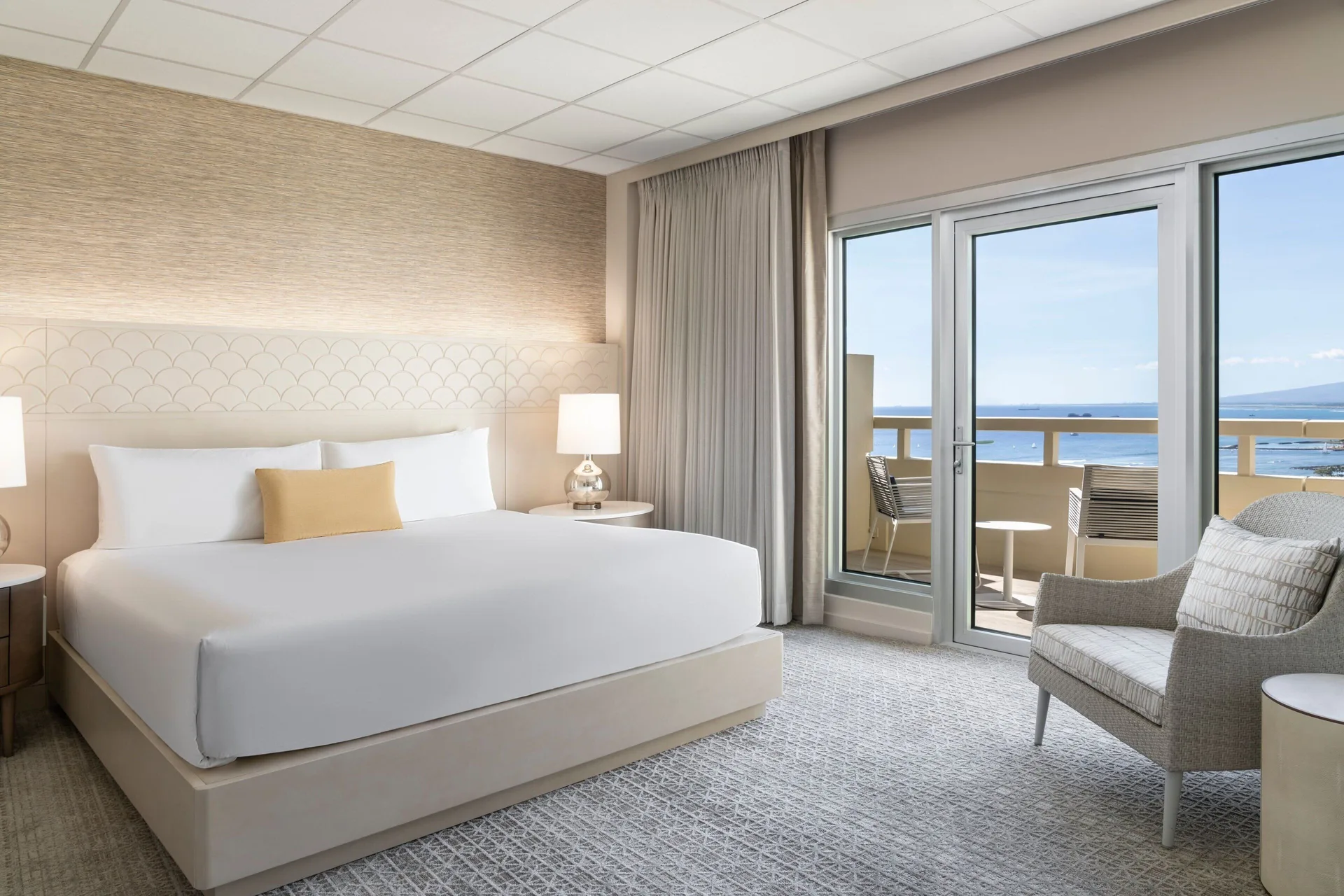 Executive Suite king bedroom with balcony and ocean view at Sheraton Waikiki Beach Resort.