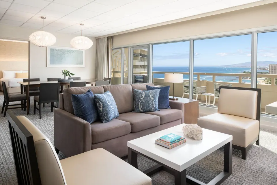 Executive Suite living and dining area with ocean-facing balcony at Sheraton Waikiki Beach Resort.