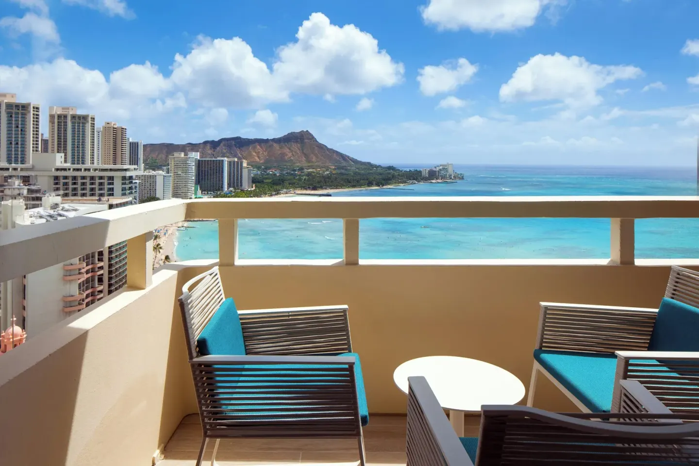 Oceanfront balcony seating overlooking Waikiki and Diamond Head at Sheraton Waikiki Beach Resort.