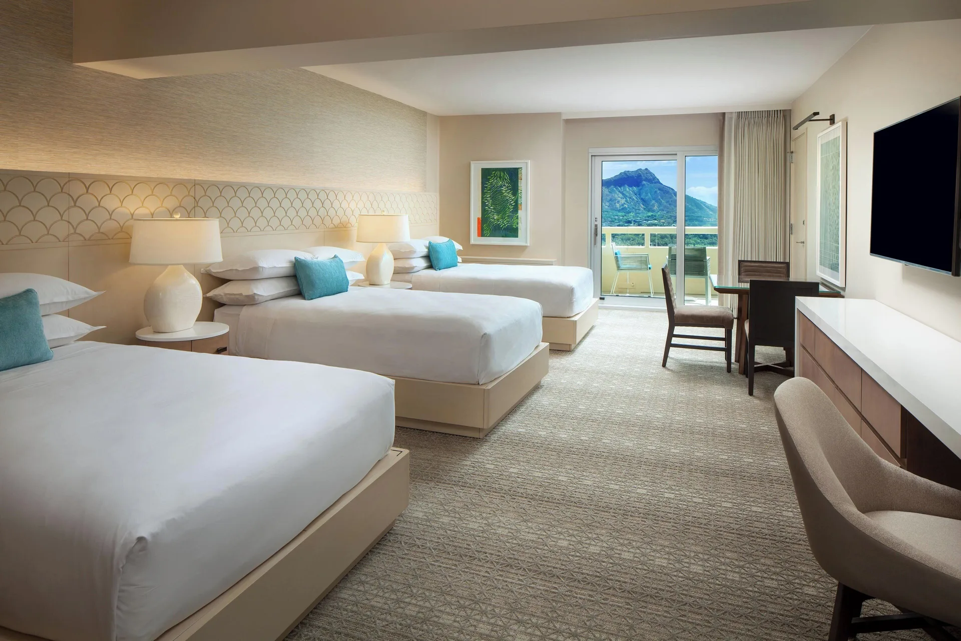 Luxury Oceanfront room with three beds and balcony view at Sheraton Waikiki Beach Resort.