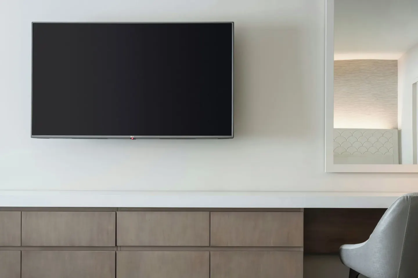 Wall-mounted TV and desk area in a guest room at Sheraton Waikiki Beach Resort.