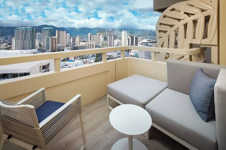 Furnished City View balcony overlooking Honolulu at Sheraton Waikiki Beach Resort.