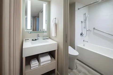 Room City View bathroom vanity and tub at Sheraton Waikiki Beach Resort.