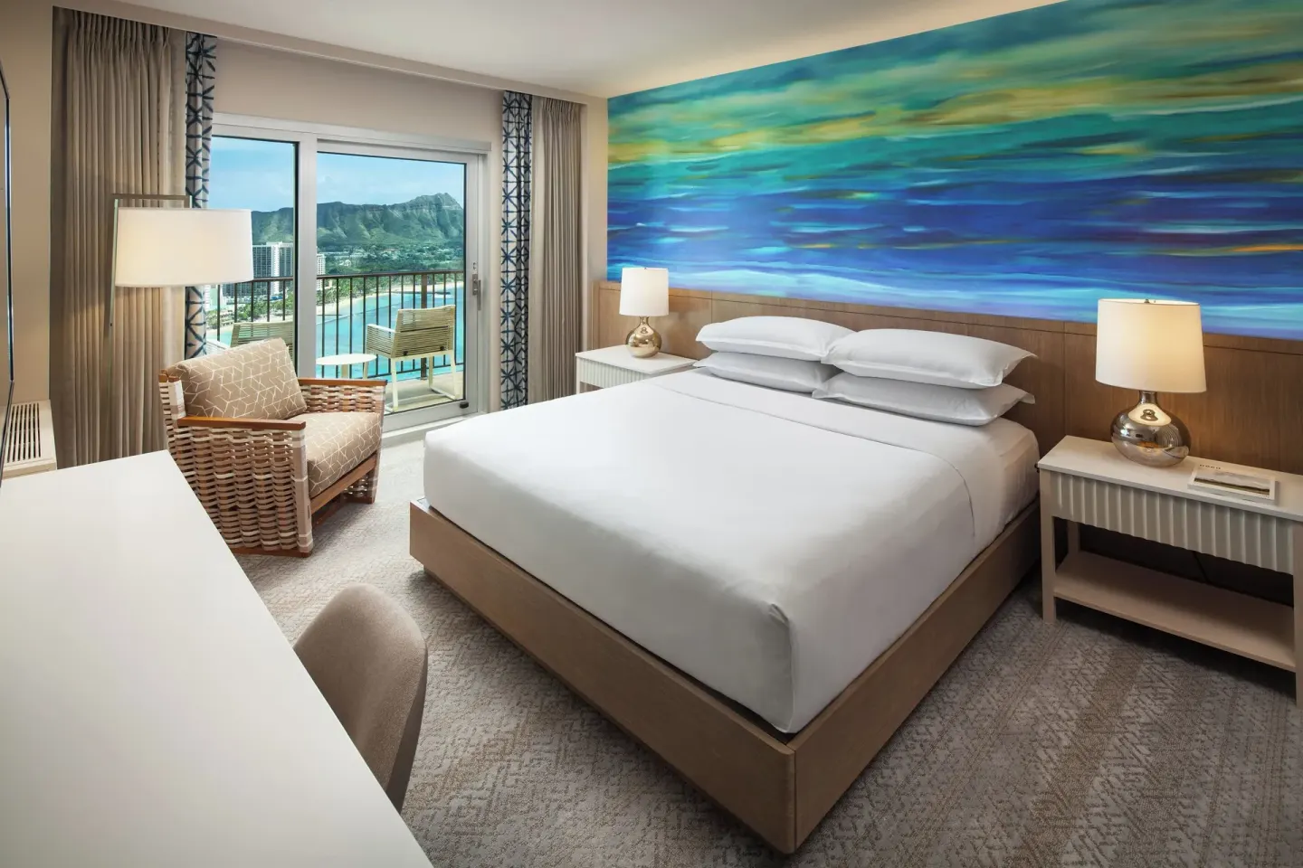 Oceanfront king guest room with Diamond Head view at Sheraton Waikiki Beach Resort.