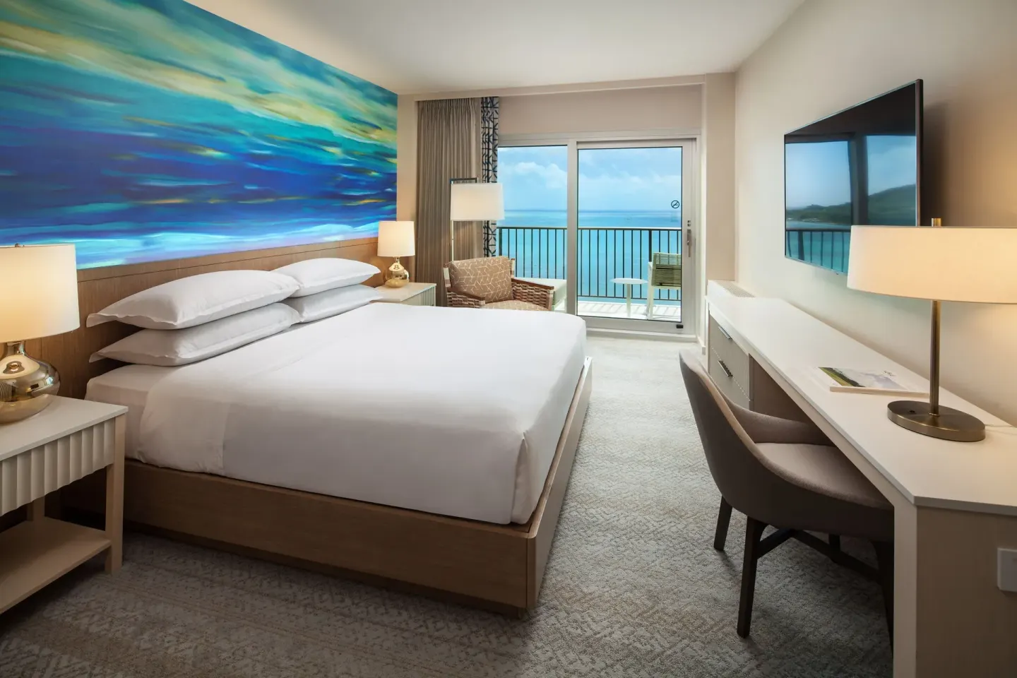 Oceanfront king guest room with balcony view at Sheraton Waikiki Beach Resort.