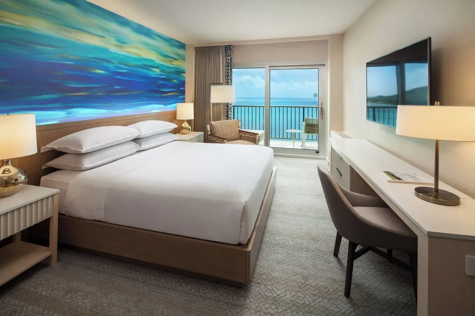Oceanfront king room with blue mural and balcony at Sheraton Waikiki Beach Resort.