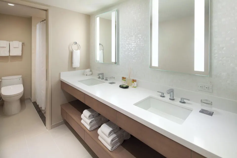 Malia Suite bathroom with double vanity and shower at Sheraton Waikiki Beach Resort.