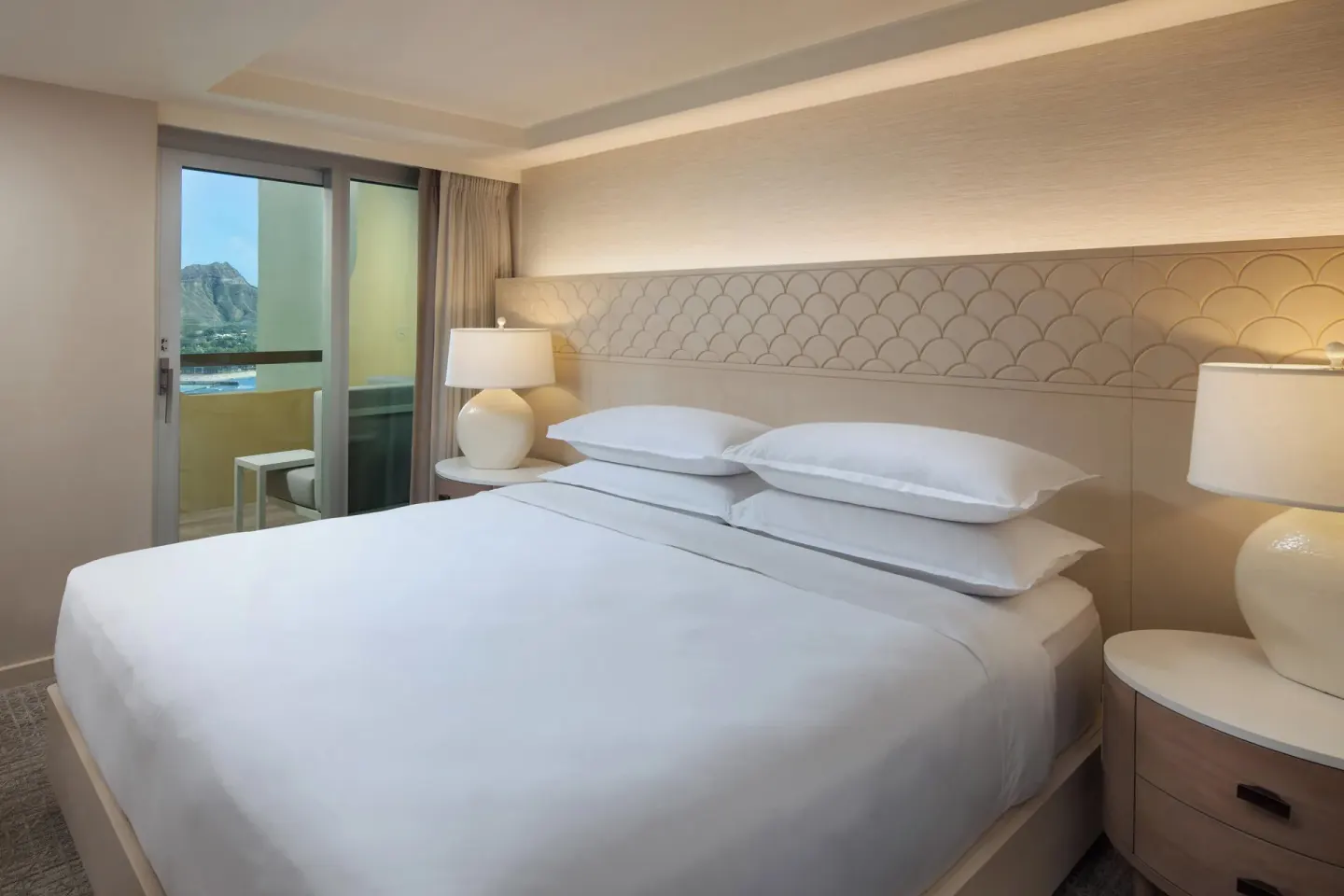 Malia Suite bedroom with king bed and balcony view at Sheraton Waikiki Beach Resort.