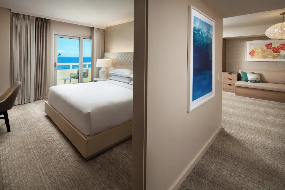 Bedroom and adjoining sitting area in the Ohana Suite at Sheraton Waikiki Beach Resort.