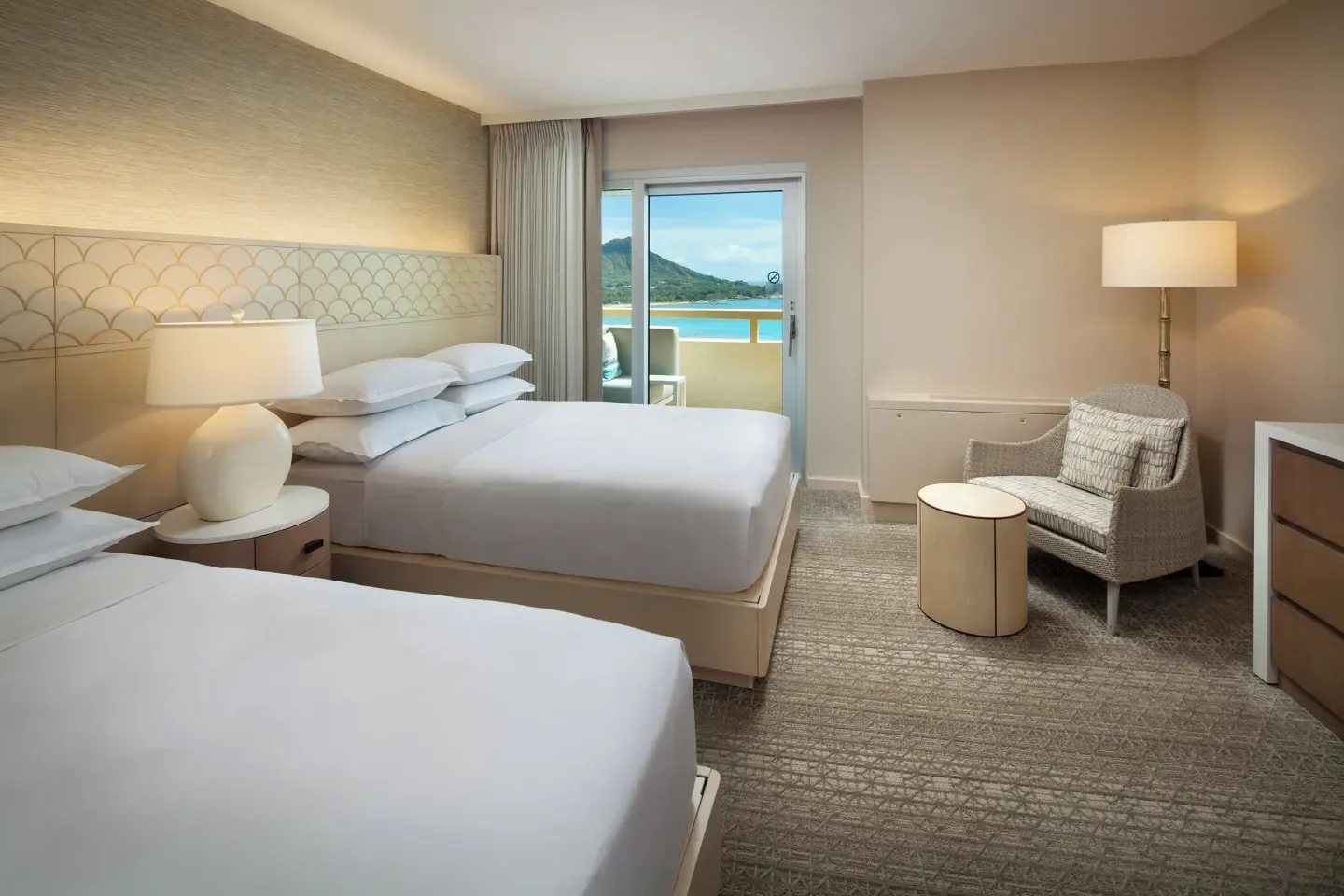 Two-bed bedroom with balcony and mountain view at Sheraton Waikiki Beach Resort.