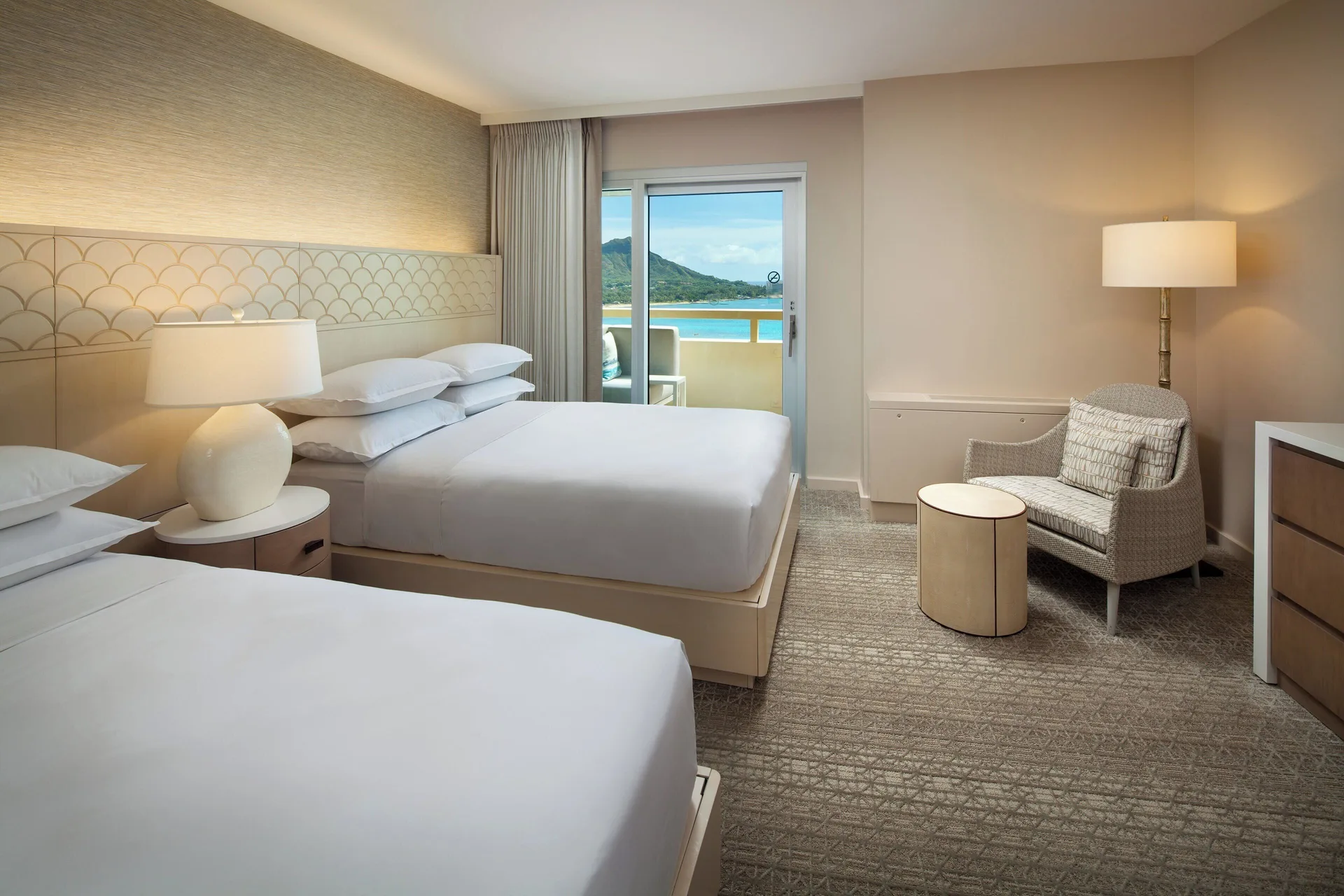 Two-bed bedroom with balcony and mountain view at Sheraton Waikiki Beach Resort.