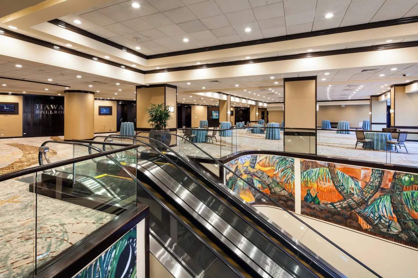 Escalators and prefunction tables near the Hawaii Ballroom at Sheraton Waikiki Beach Resort.