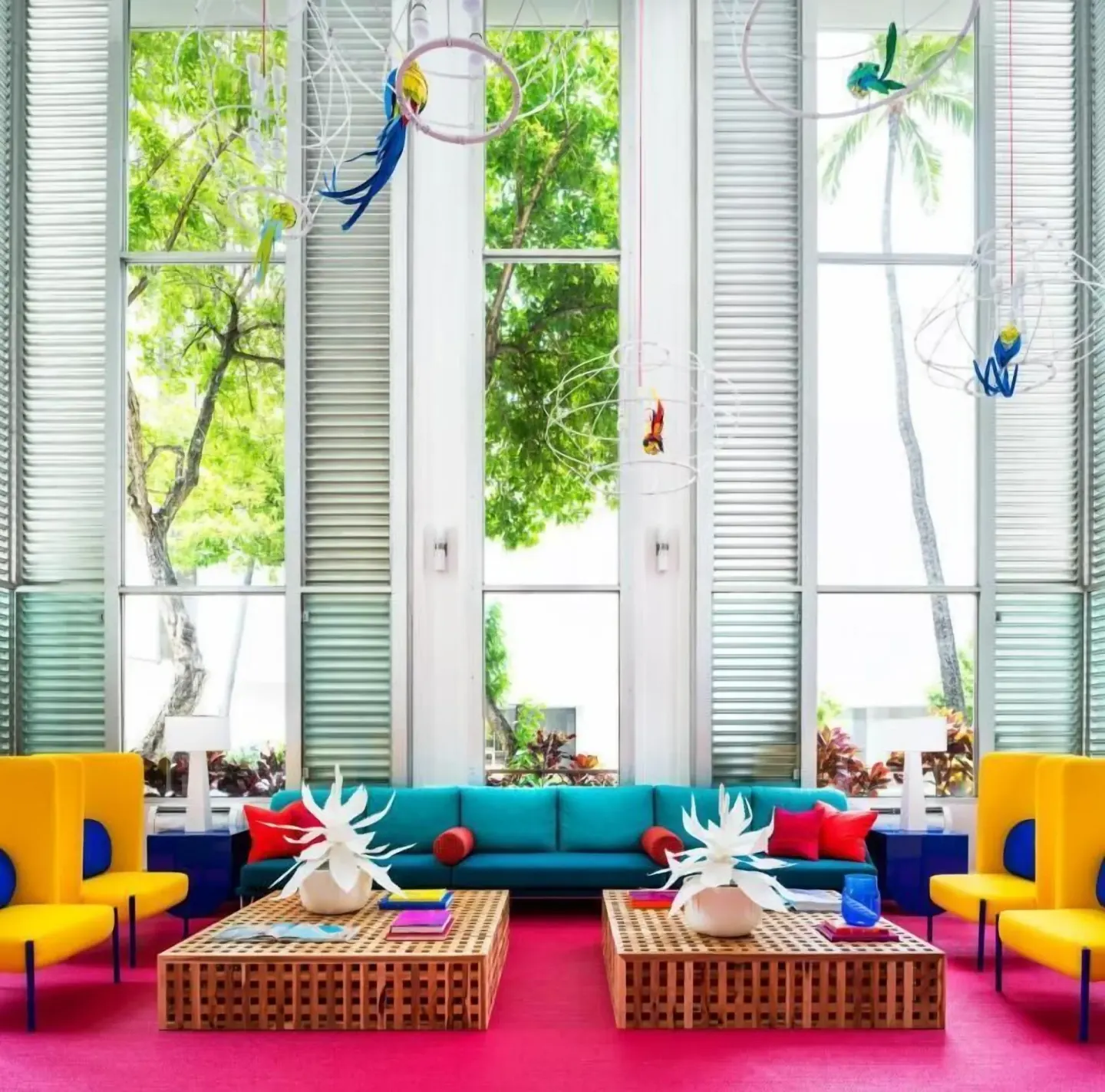 Colorful lobby seating and tall windows at Shoreline Hotel Waikiki.
