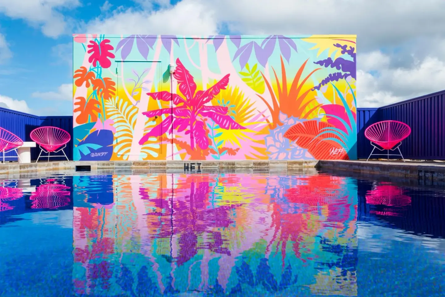 Rooftop pool reflecting a colorful tropical mural at Shoreline Hotel Waikiki.