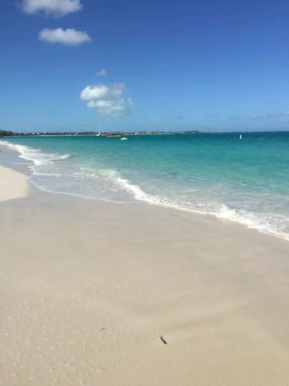 Curving sandy shoreline and turquoise water near Sibonné Beach Hotel.